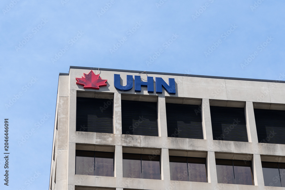 Naklejka premium Toronto, Ontario, Canada - June 2, 2026: Closeup of UHN logo on top of the Princess Margaret Cancer Centre building on University Avenue in Toronto, Ontario, Canada. UHN is recognized as the Canadian