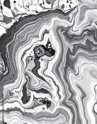 A grayscale abstract image featuring swirling wavy patterns
