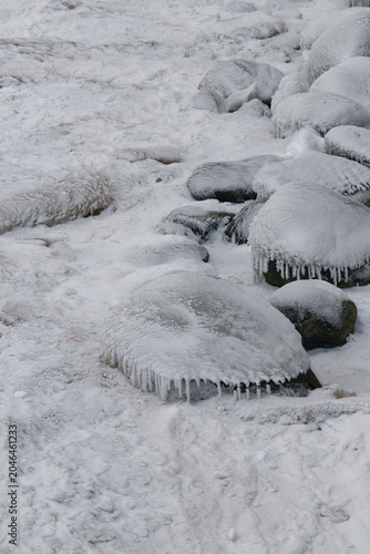 Rocks covered in snow and ice in winter landscape