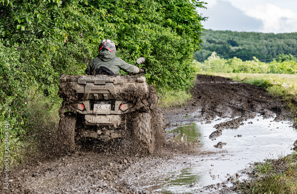 Φωτογραφία ATV Rider Splashing Through Muddy Off Road Trail Extreme Quad Bike Adventure in Countryside Landscape