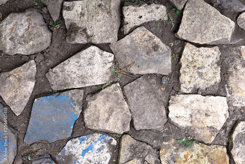 Irregular stone paving with soil and blue fragment