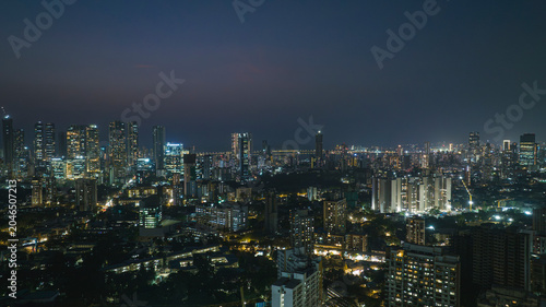 Cinematic aerial view of Mumbai city at night. Mumbai's iconic financial district with this stunning cityscape view—Shot of Mumbai Skyline, high-rise buildings in South Mumbai, Maharashtra, India.