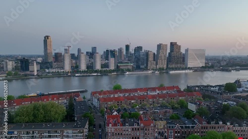 Drone flight over Rotterdam, Netherlands. New skyscrapers, city canyon, navigable canals and drawbridges in the light of sunset or sunrise, drone shot. 4K