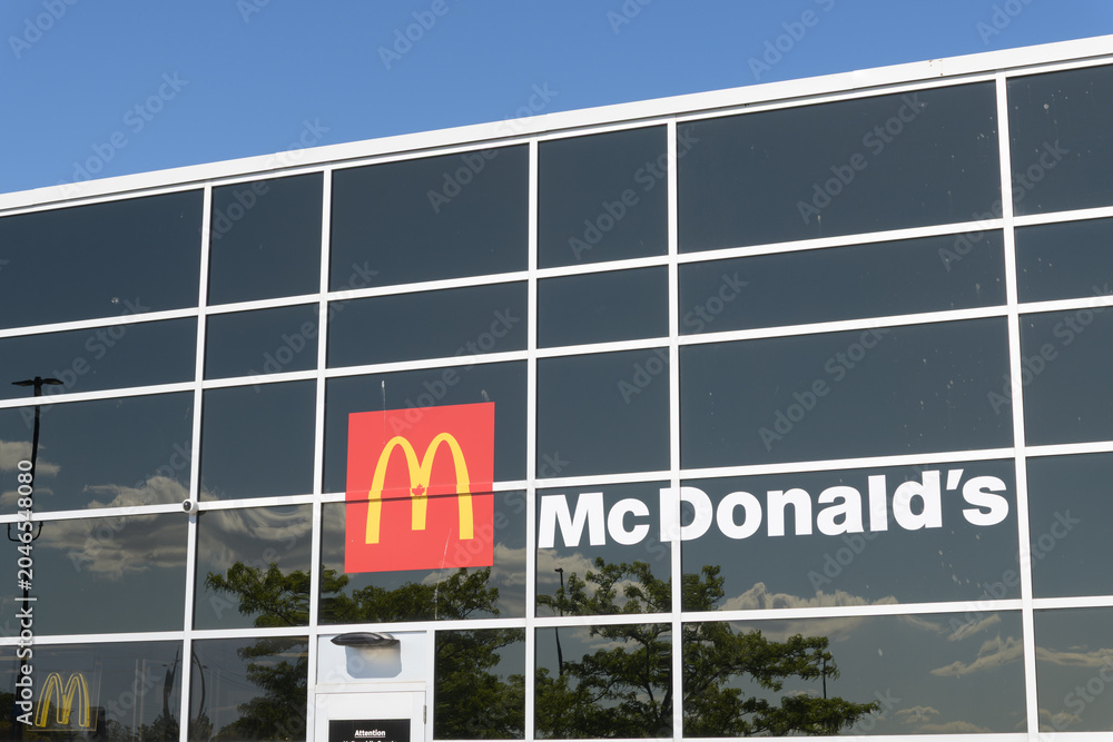 Obraz premium exterior building and sign of McDonald's, a fast food restaurant, located at 2525 St Clair Av W, inside Walmart Supercentre, Toronto