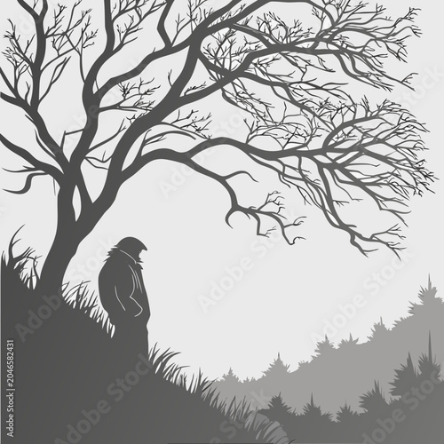 Obraz na płótnie Silhouette of a solitary person standing under a large barren tree in a forest w