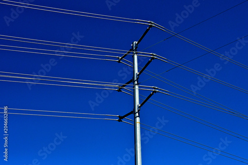 Dual cables spaced roughly 1 foot  apart on high-voltage transmission towers are used to reduce corona discharge and manage electrical field intensity.