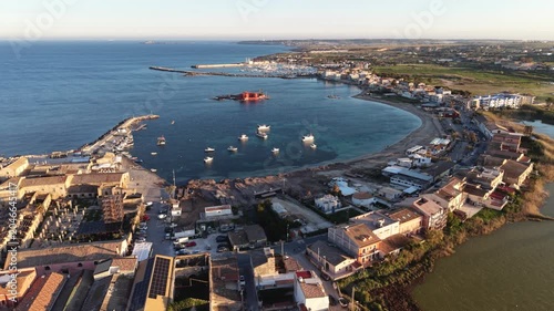 Aerial view of the historic fishing village of Marzamemi and the Tonnara with its harbor and blue Mediterranean waters, Marzamemi, Sicily, Italy.
