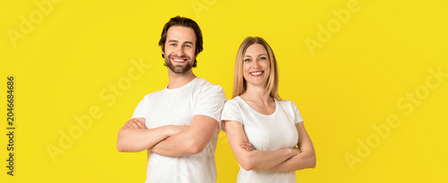 Bild auf Leinwand Smiling Caucasian Man And Woman In Their 20s With Arms Crossed, Standing Togethe