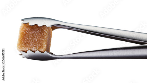 Photos Isolated shiny stainless steel sugar tongs gripping a single natural brown sugar