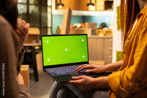 Bild auf Leinwand Green screen laptop, happy couple, redecoration in new house, thinking about furniture layout in their first home, Domestic lifestyle scene illustrating ownership, fresh start indoors