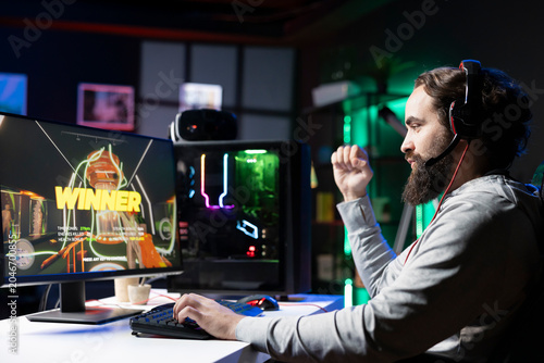 Obraz na plátne Happy gamer feeling relieved after finally receiving winner screen for killing all enemies in first person shooter