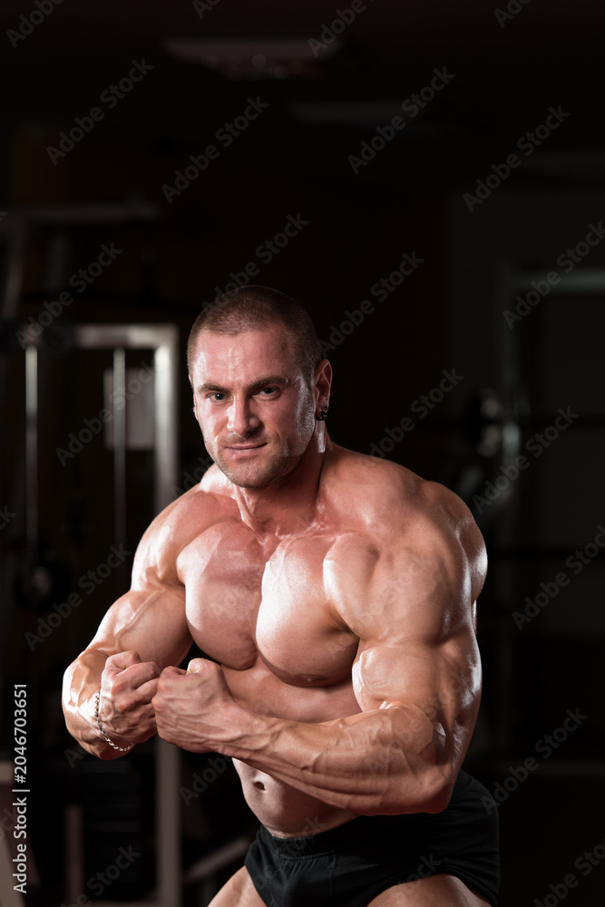 Fototapeta premium Young Bodybuilder Flexing Muscles
