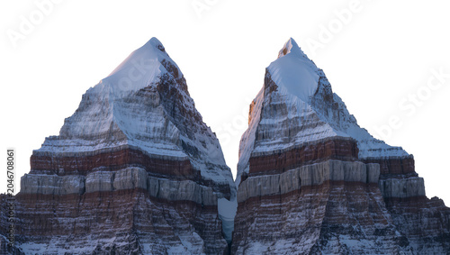 Isolated majestic snow-capped mountain peaks with striking layered rock formations and dramatic rugged slopes
