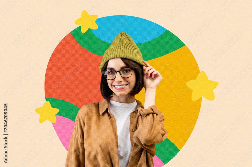 Fototapeta premium Happy Young Woman With Glasses And Green Beanie Smiling While Posing Against Colorful Background, Displaying Joy And Positivity In Lifestyle Setting. Capturing Lightheartedness And Fun Concept