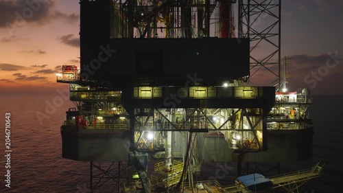 Aerial view of offshore jack up rig and offshore platform during sunset for oil and gas exploration and production. 