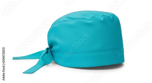 A professional aqua blue surgeon cap with a ribbon tie closure is shown in an elegant studio composition against a clean white background, medical hat, aqua blue, object