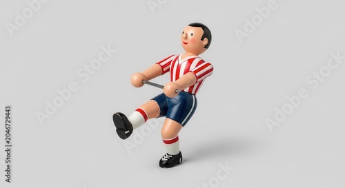 Table Football Player Kicking Ball on Gray Background.