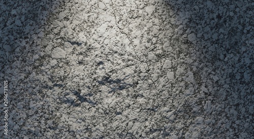 Textured concrete wall with dramatic spotlight effect.