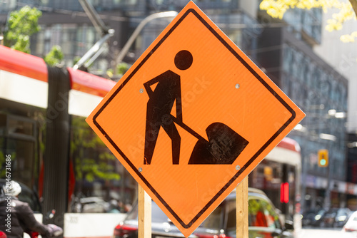 Canvas Print Toronto, Canada - May 26, 2026: Urban Construction Warning Sign with Streetcar a