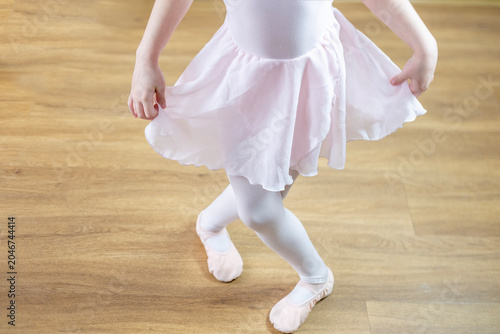 Obraz na płótnie young aspiring ballerina, 5 years old, dances in soft pink leotard, embodying ch