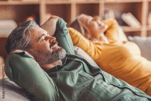 Photos Smiling Happy Elderly Caucasian Man And Woman Relaxing Together On Couch At Home