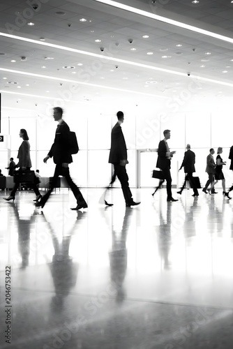 Business professionals walking through a modern airport terminal highlighting corporate travel mobility and global business activity
