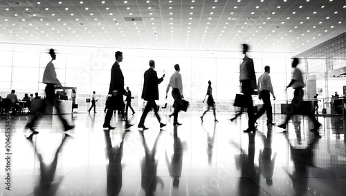 Business professionals walking through a modern airport terminal highlighting corporate travel mobility and global business activity
