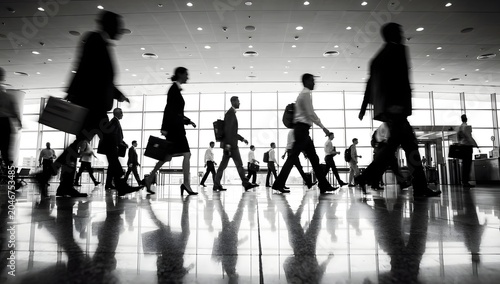 Business professionals walking through a modern airport terminal highlighting corporate travel mobility and global business activity
