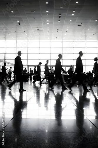 Business professionals walking through a modern airport terminal highlighting corporate travel mobility and global business activity

