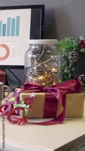 Vertical video: Pulling back camera revealing kraft gift box on desk to show jar lights, charts