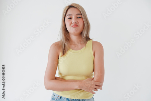 Foto Young Thai Asian woman pouting, looking displeased with a humorous expression on a white background