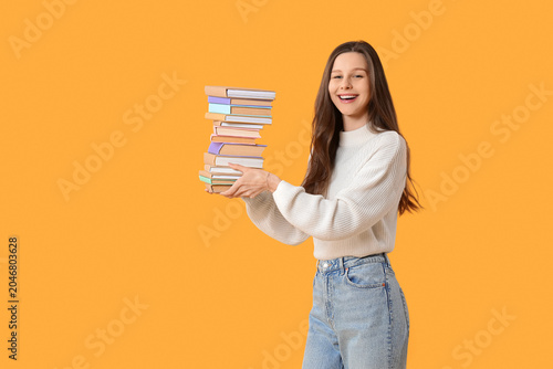 Young woman with stack of b...