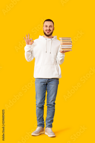 Young man with stack of boo...