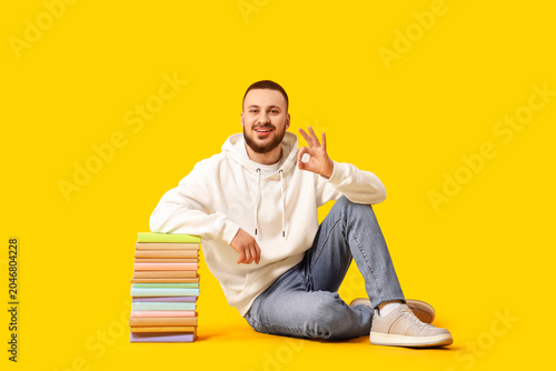 Young man with stack of boo...