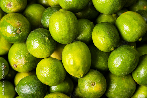 Fresh citrus fruits with ripe, textured Persian limes, Tahitian - Citrus x latifolia