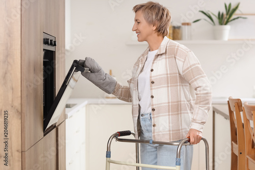 Mature woman with walker op...