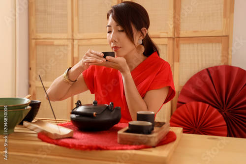Young Asian woman with cup ...