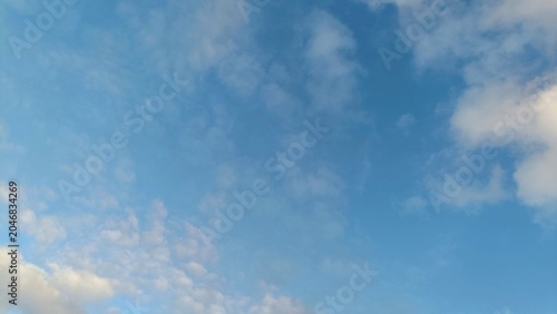 Bild auf Leinwand Beautiful bright blue sky with scattered white fluffy clouds on a clear sunny day