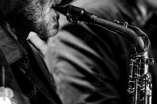 Saxophone close up with dramatic light jazz music concept  copyspace
Close up of a saxophone with dramatic lighting highlighting metallic texture. Music concept representing jazz, 
performance, elegan
