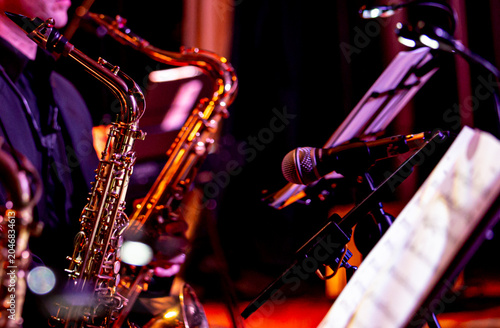 Saxophone close up with dramatic light jazz music concept  copyspace
Close up of a saxophone with dramatic lighting highlighting metallic texture. Music concept representing jazz, 
performance, elegan