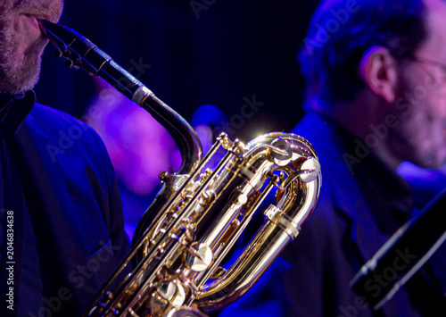 Saxophone close up with dramatic light jazz music concept  copyspace
Close up of a saxophone with dramatic lighting highlighting metallic texture. Music concept representing jazz, 
performance, elegan