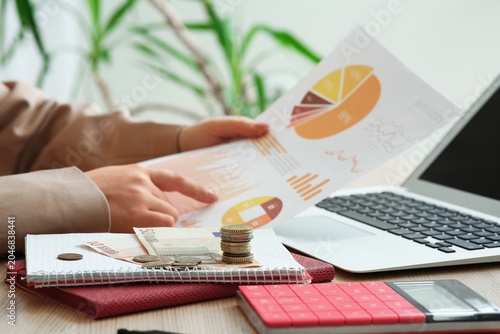 Money on notebooks against ...
