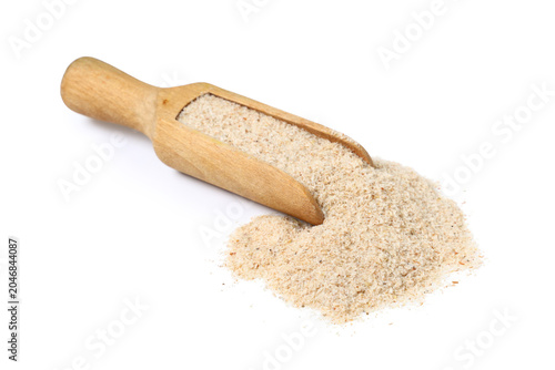 Fotografie Scoop with psyllium husk powder on white background