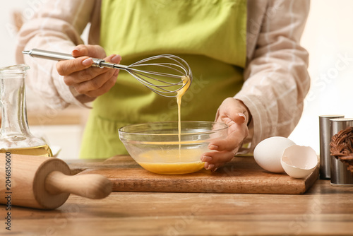 Woman preparing dough with ...