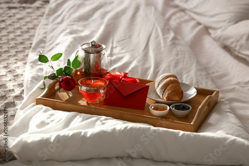 Tray with breakfast, rose a...