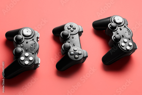 Modern game pads on red bac...