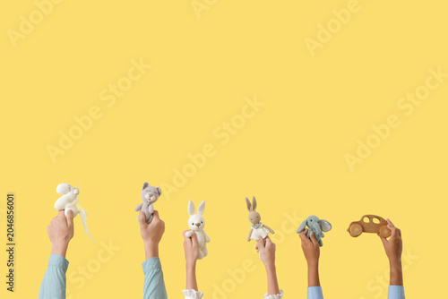 Photos Children with different toys on yellow background