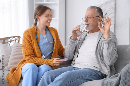 Senior man with caregiver t...