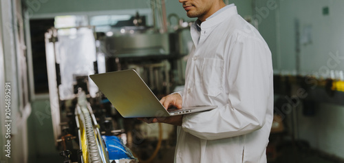 Employees inspecting health drink products from the manufacturing plant.