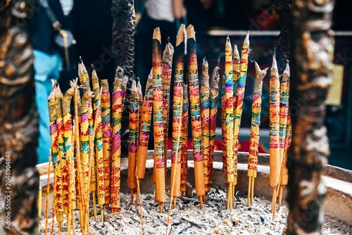 Canvas Print Close up of burning colorful joss sticks with auspicious characters meaning bles